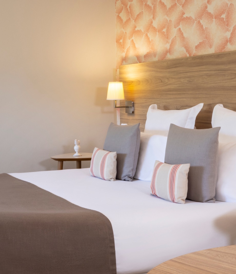 Chambre confortable au Lou Paradou Hotel, avec un lit douillet orné de coussins élégants et une décoration apaisante. Idéale pour un séjour relaxant, cette chambre dispose d'un ambiance sereine, parfaite pour les visiteurs en quête de bien-être et de tranquillité.